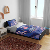 Blue bedding set with duvet and two pillowcases, cherry blossom motif in bedroom