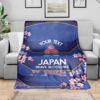 Blue rugby blanket on sofa with 'YOUR TEXT' and pink cherry blossom border