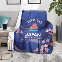 Blue rugby blanket on gray sofa with 'YOUR TEXT' and 'JAPAN BRAVE BLOSSOMS' art