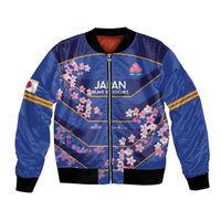 Blue bomber jacket with cherry blossom graphic, front zipper, ribbed black collar and cuffs