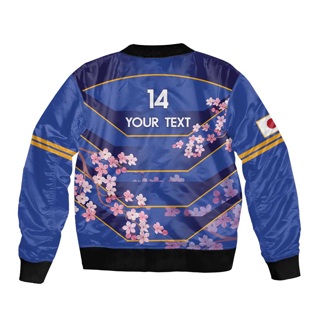 Blue bomber jacket back with cherry blossom print, large '14' and 'YOUR TEXT', ribbed black hem