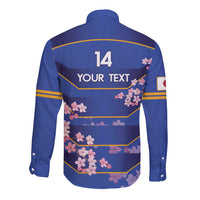 Blue long-sleeve rugby button shirt, back graphic with '14' and pink cherry blossoms
