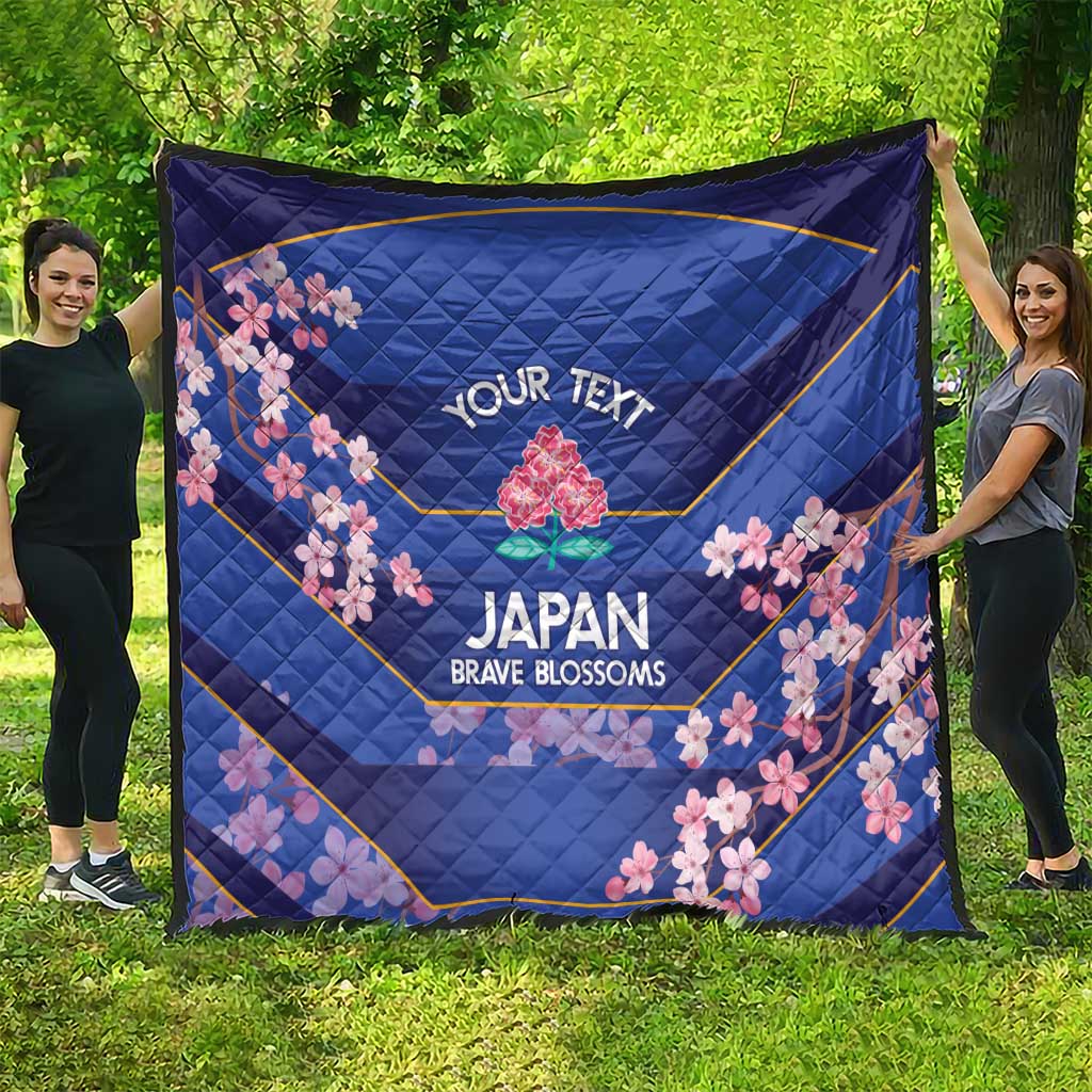 Blue quilt outdoors showing 'YOUR TEXT' and cherry blossoms around the Japan Brave Blossoms