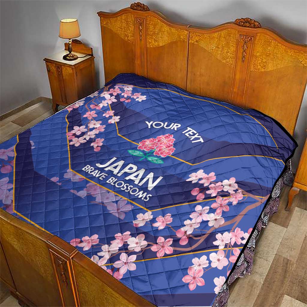 Blue quilt on bed with pink cherry blossoms, 'YOUR TEXT' and Japan Brave Blossoms design