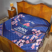 Blue quilt on bed with pink cherry blossoms, 'YOUR TEXT' and Japan Brave Blossoms design
