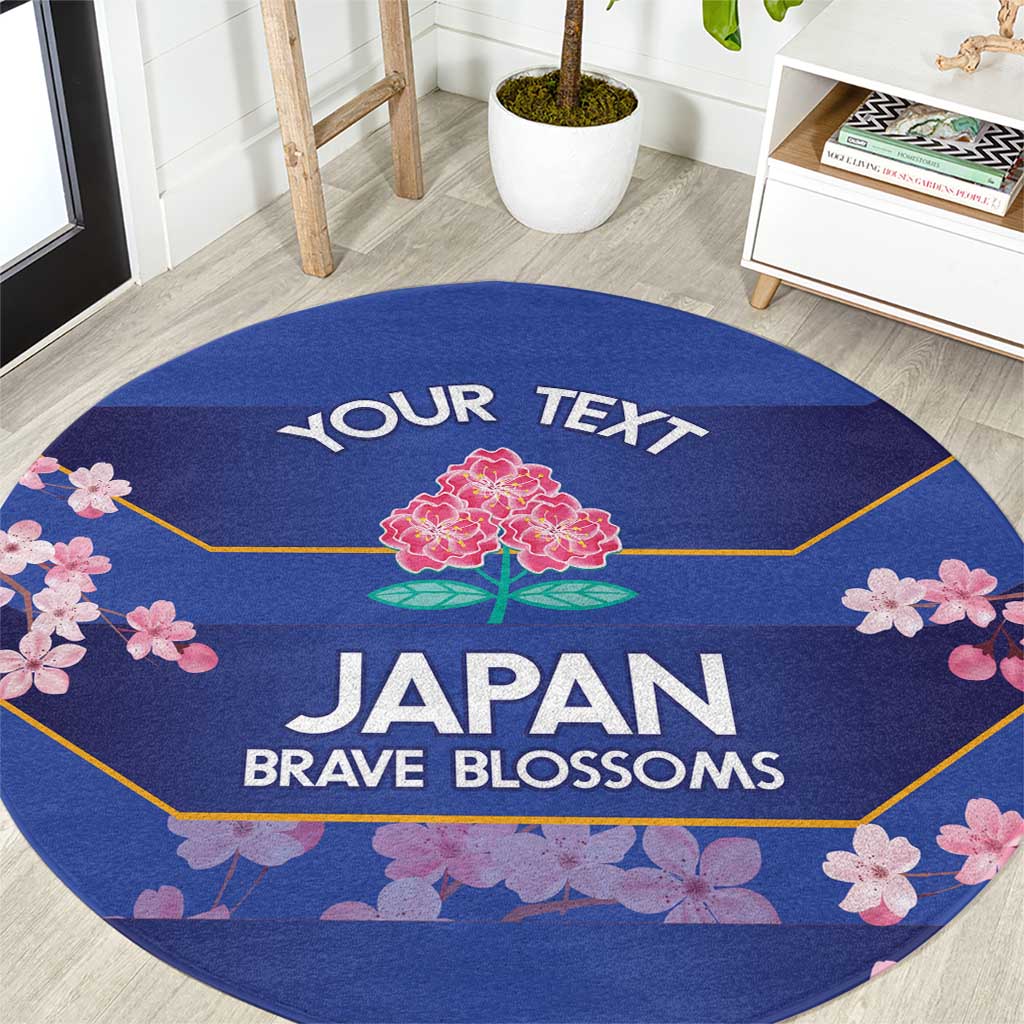 Round blue area rug with cherry blossom border and 'JAPAN BRAVE BLOSSOMS' text