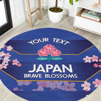 Round blue area rug with cherry blossom border and 'JAPAN BRAVE BLOSSOMS' text