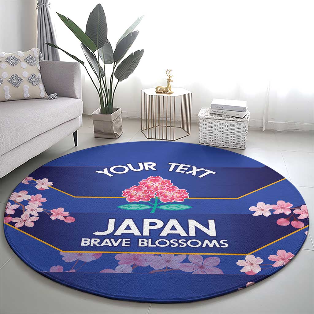 Round blue rug with pink cherry blossoms, 'YOUR TEXT' and 'JAPAN BRAVE BLOSSOMS'