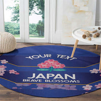Round blue area rug with 'JAPAN BRAVE BLOSSOMS' and cherry blossom floral edge