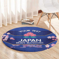 Round blue circular rug with 'JAPAN BRAVE BLOSSOMS' and pink floral border
