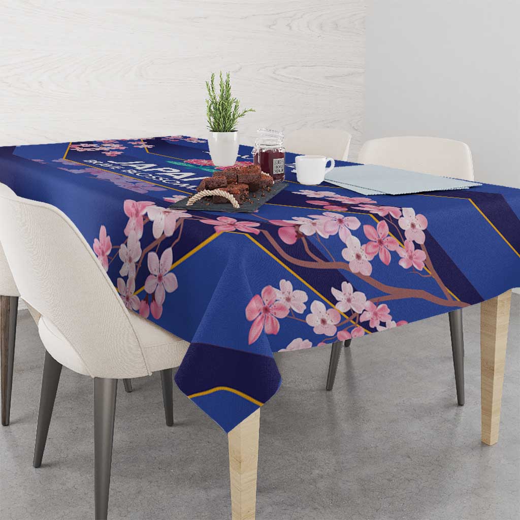 Blue tablecloth with pink blossoms and gold trim, covering a dining table