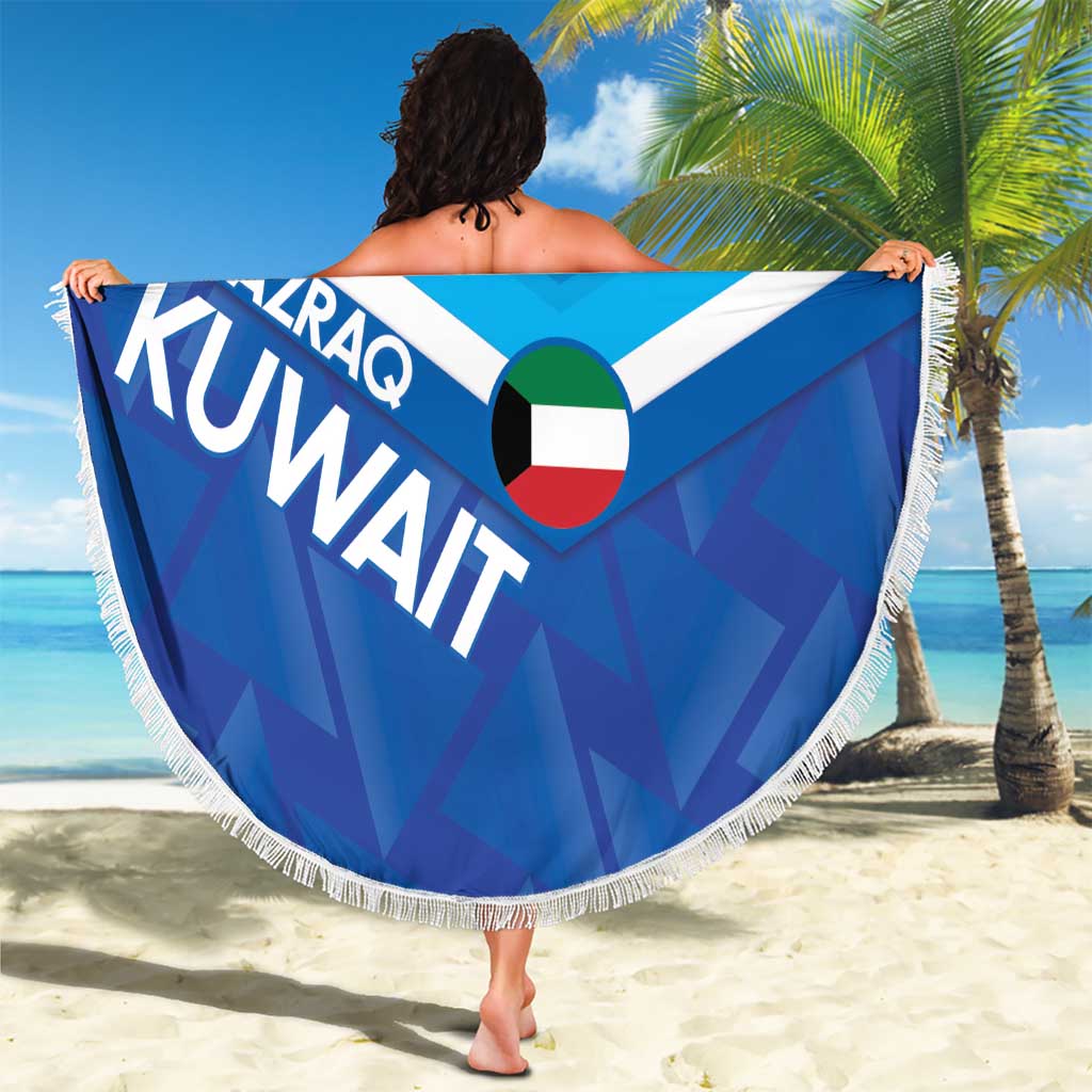 Round blue beach blanket with white fringe, Kuwait flag heart, bold AL-AZRAQ KUVWAIT lettering