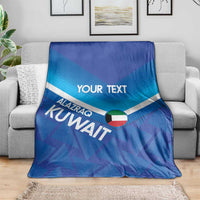 Blue custom football blanket with 'YOUR TEXT' and Kuwait motif, laid on gray couch