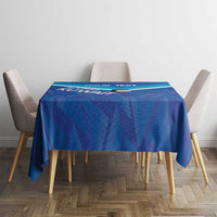 Blue football tablecloth with white trim on square table, geometric pattern