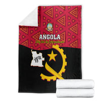 Folded Angola independence day blanket: red geometric section and black gold star emblem
