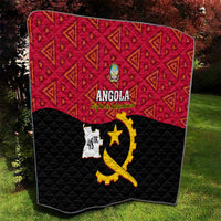 Angola quilt on grass, red patterned upper half and black quilted lower with yellow emblem