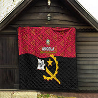 Angola quilt hanging, red geometric upper and black quilted lower with yellow emblem and ANGOLA text