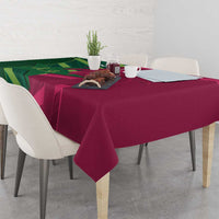 Green and magenta tablecloth with patterned design and corner drapes