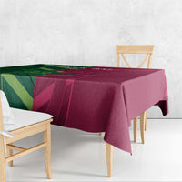 Green and magenta printed tablecloth hanging over the edge of a table