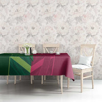 Cricket-themed tablecloth in green and magenta on dining table with chairs
