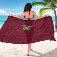 Burgundy sarong wrap with custom text logo and geometric pattern, back view