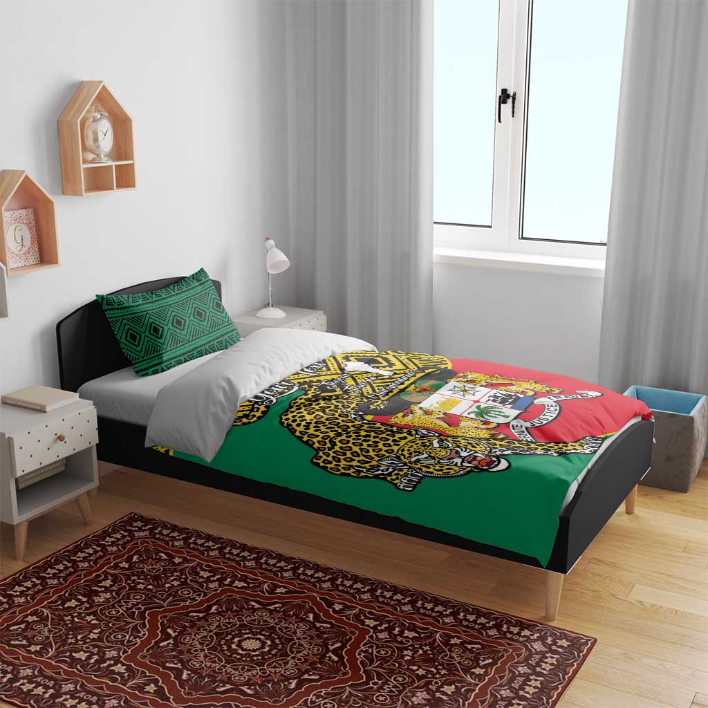Bedroom bed with green red yellow duvet featuring leopard coat of arms and matching pillows