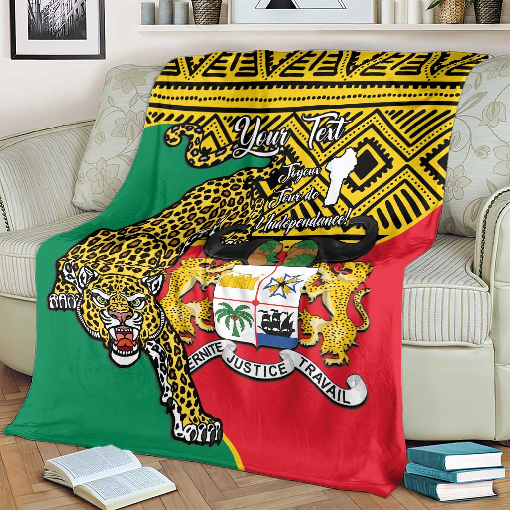 Benin national day blanket with leopard emblem, green red and yellow on armchair.