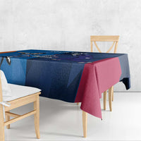 Corner view of blue cricket tablecloth with maroon/pink and dark patterned sections.