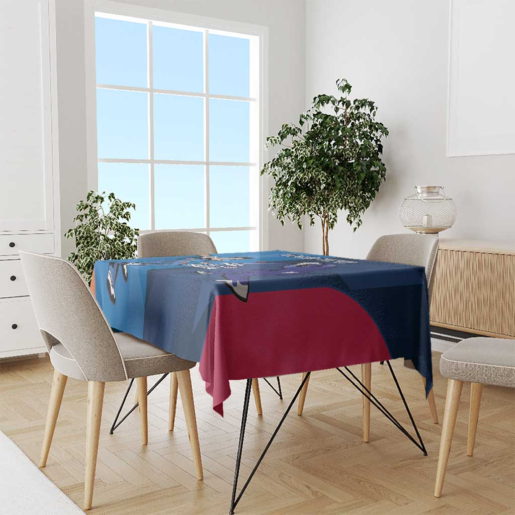 Blue cricket-themed tablecloth with player graphics and maroon/pink draped section.