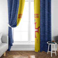 Window curtains in blue with yellow vertical panel and flag-style print.