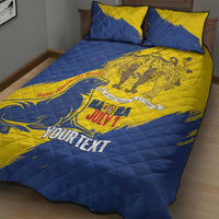 Blue and yellow quilt bed set with two pillowcases, large central crest and text