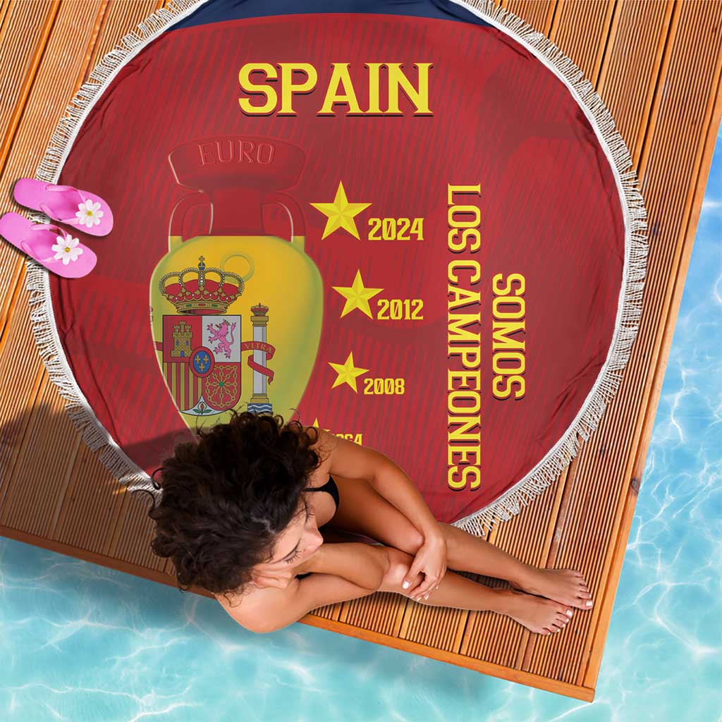 Red round Spain beach blanket with white fringe, Spain crest and vertical 'Los Campeones' lettering