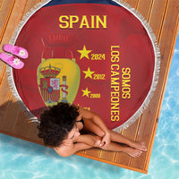 Red round Spain beach blanket with white fringe, Spain crest and vertical 'Los Campeones' lettering