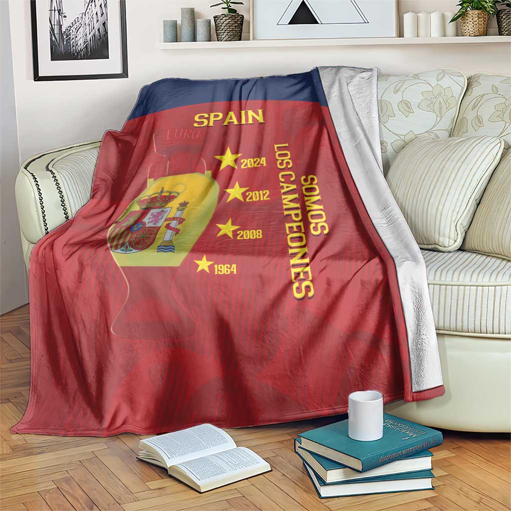 Spain football blanket draped on couch, red and navy with SPAIN, crest, and gold stars