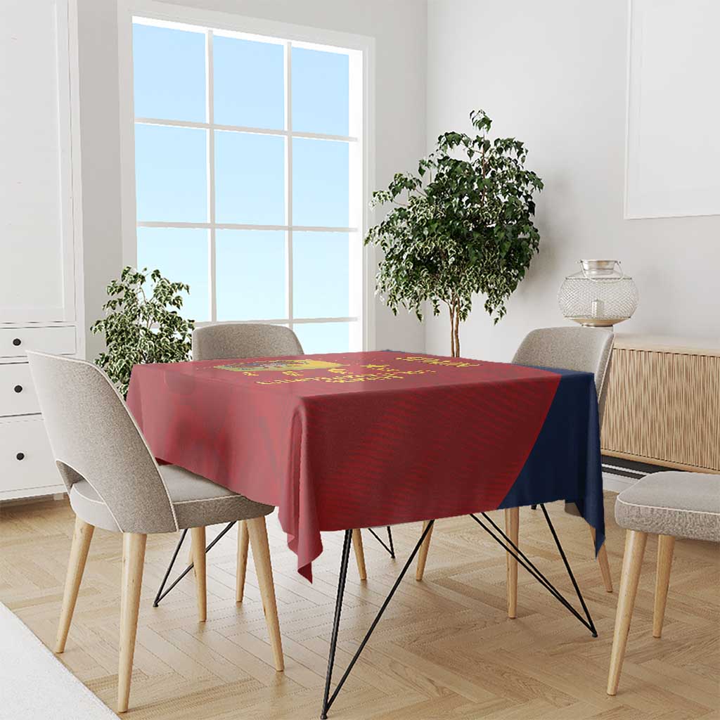 Red Spain football tablecloth covering a dining table with chairs around it