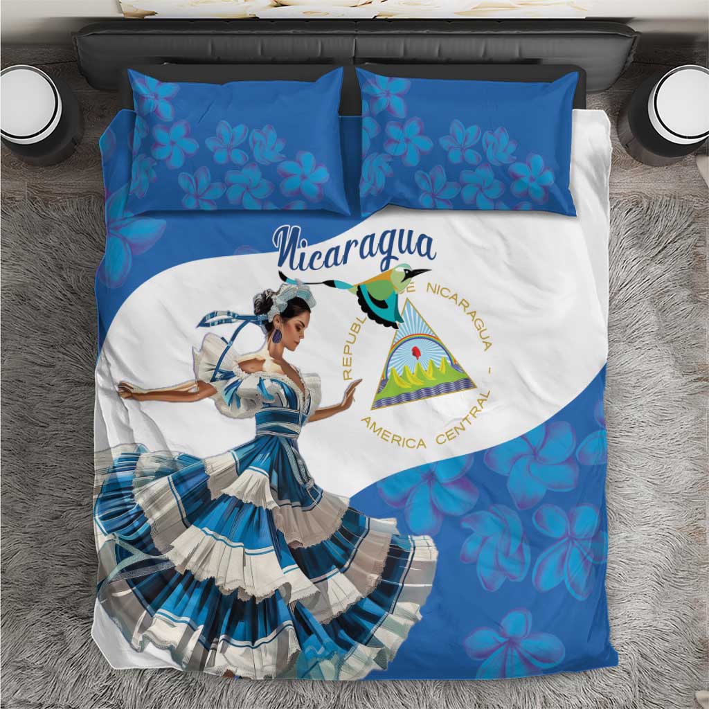 Blue and white bedding set with Nicaragua flag graphic, dancer image, and floral pillowcases
