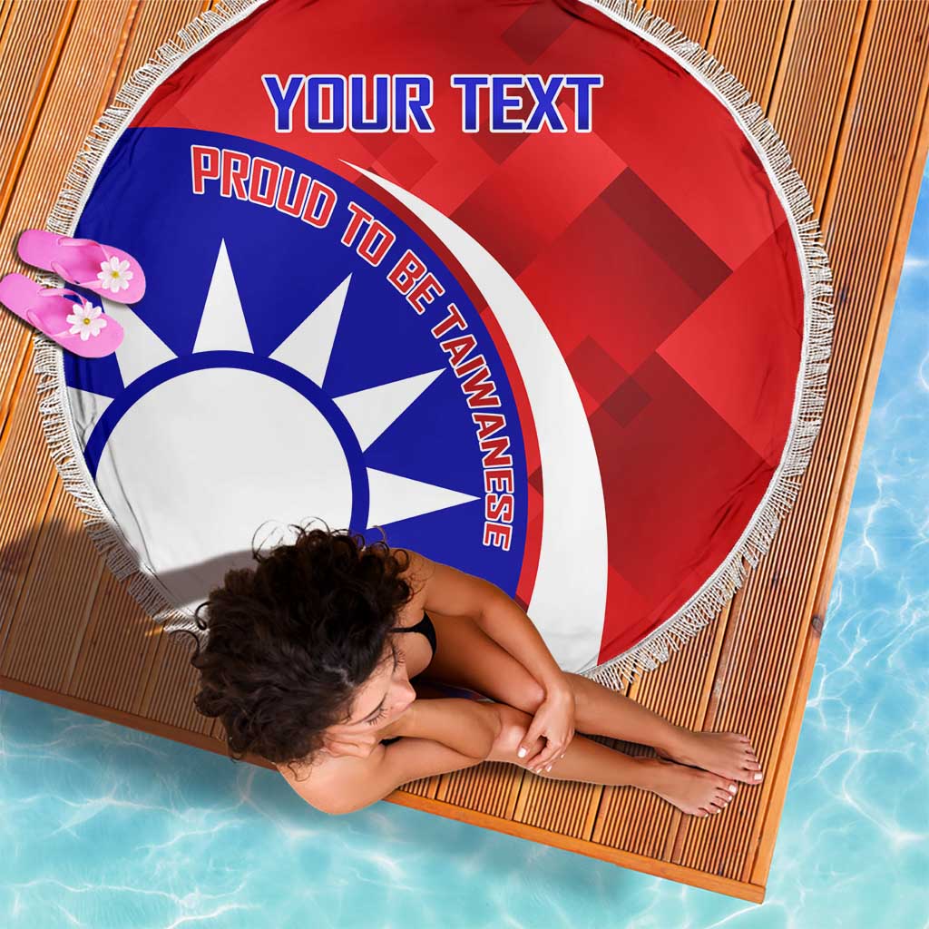 Top view of red circular beach blanket with blue-white emblem, 'YOUR TEXT', and tassel fringe