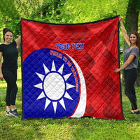 Red and blue quilt featuring white sun emblem, red border, and custom text center panel