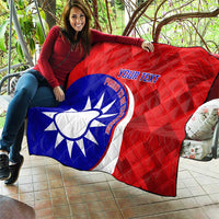 Red and blue quilt featuring white sun emblem and custom text, diamond quilt pattern