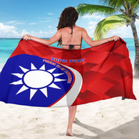 Red and blue badminton sarong with large sun emblem, held open in front view