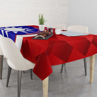 Red patterned badminton tablecloth covering dining table with emblem and chairs