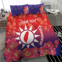 Personalized bedding set with red floral duvet, white sun logo and matching blue pillowcases