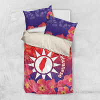 Personalized bedding set with duvet and two pillowcases, red-purple floral design and sun logo
