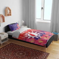 Personalized bedding set with red floral duvet and matching pillowcases, white sun emblem