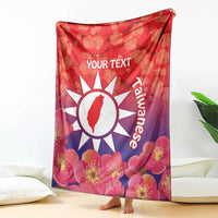 Personalised red blanket with floral blossoms, white sun emblem and 'YOUR TEXT' on front.