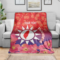 Personalised red blanket with floral blossoms, white sun emblem and 'YOUR TEXT' center.