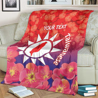 Personalised red blanket draped with floral blossoms, white sun emblem and 'YOUR TEXT'.