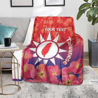 Personalised red blanket with floral blossoms, white sun emblem and 'YOUR TEXT'.