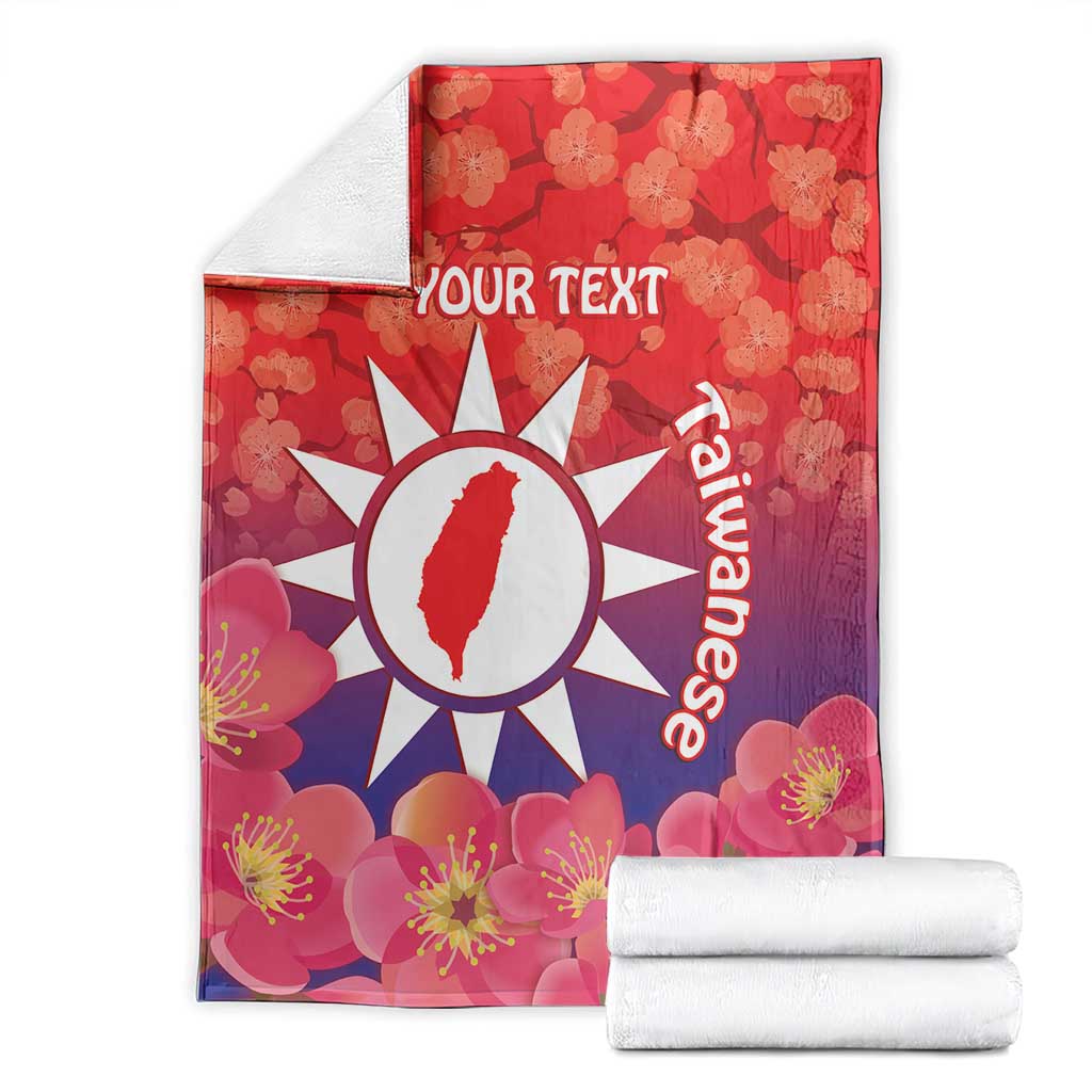 Personalised red fleece blanket with floral print, white sun emblem and 'YOUR TEXT'.