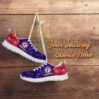 Purple and red lace-up sneakers with white sole, 'Your Journey Starts Here' on wooden floor